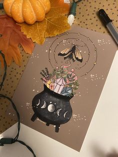 a card with an image of a potted plant and butterflies on it, surrounded by autumn leaves