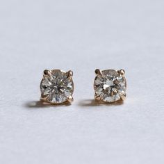 A pair of classic diamond stud earrings Metal: 18K Yellow Gold Stone: Natural Diamond Diamond Color and Clarity: I/J, VS Prong: 4 Stone Size: 5mm Stone Weight: 0.5 carat Total carat weight: 1 carat Rose Gold Single Diamond Earrings For Anniversary, Refined Yellow Gold Diamond Earrings, Classic Jewelry With Single Cut Diamonds, Classic Rose Gold Earrings For Everyday Luxury, Minimalist Single Cut Diamond Earrings For Formal Occasions, Luxury Anniversary Diamond Earrings With Single Cut Diamonds, Refined 14k Gold Earrings For Anniversary, Luxury Single Cut Diamond Earrings For Anniversary, Classic Brilliant Cut Diamond White Earrings