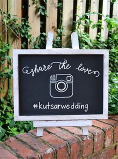 a sign that says share the love with a camera