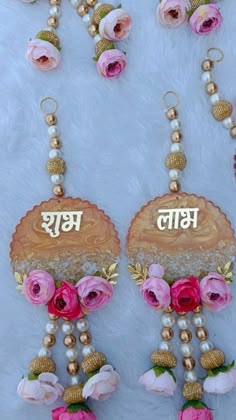 two necklaces with flowers and beads hanging from them