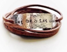 "Wear your daily affirmations and inspirational words on your wrist to remind yourself of what is most important to you every day. :) This leather wrap bracelet features the phrase \"Let Go and Let God\", hand stamped onto hammered aluminum. The soft brown faux suede leather cord is approximately 36\" long and can usually wrap around the wrist 2 times. The. Just tie a loose knot or two in the back to secure and you are good to go! You can have this bracelet with or without the tiny cross at the Let Go Let God, God Hand, Let Go And Let God, Christian Bracelets, Boho Wrap Bracelet, Tiny Cross, Stamped Bracelet, Let God, Bracelet Women