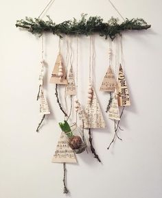 a group of wooden ornaments hanging on a wall next to a plant and some string