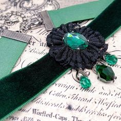 Dear customers, for a price offer of expedited shipping outside of Germany, please contact me directly via Etsy messages. A Gothic Victorian green choker, a romantic and elegant design with a black lace flower and a green Swarovski pendant with 3 green droplets, made to bloom with your gothic dress, special event or any romantic outfit. Goth fashion is distinguished by darkness, mystery, elegant wardrobe pieces and, smoky makeup even though it may surprise some that not all Goths always wear bla Handmade Halloween Choker As Gift, Handmade Halloween Choker Gift, Handmade Halloween Choker For Gift, Adjustable Green Handmade Choker, Gothic Green Jewelry For Gifts, Green Gothic Jewelry For Gifts, Green Gothic Style Jewelry Gift, Green Gothic Jewelry Gift, Elegant Green Festival Necklace