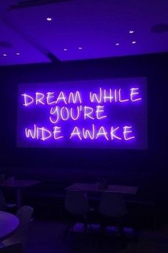 a neon sign that reads, dream while you're wide awake on the wall