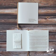 an open book sitting on top of a wooden table next to a pair of scissors