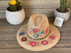 This beautiful Mexican Sombrero has beautiful hand painted flowers, perfect to add that special touch to any outfit. The hat itself is made out of jute material and is very light and breathable. Bohemian Multicolor Hand Painted Straw Hat, Bohemian Hand Painted Panama Hat With Flat Brim, Bohemian Hand Painted Hats For Spring, Artisan Multicolor Sun Hat For Spring, Adjustable Hand Painted Bohemian Panama Hat, Bohemian Adjustable Hand Painted Panama Hat, Adjustable Bohemian Hand Painted Panama Hat, Handmade Multicolor Panama Hat For Spring, Handmade Artisan Panama Hat For Spring