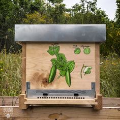 a wooden box with some plants painted on it