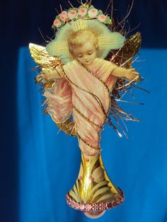 an angel ornament hanging on a blue background