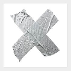 an x made out of silver foil on a white background