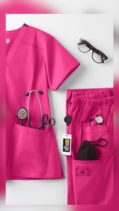 pink medical scrubs and eyeglasses laid out on a white surface