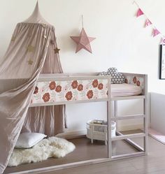 a child's bedroom with a bed and tent