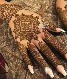 henna designs for hands and feet with intricate patterns on the palm, which is decorated with