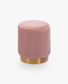 a pink stool with gold trim and a round foot rest on the top of it