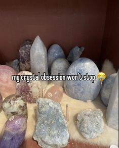 some rocks and stones are on display in a box with the words my crystal obeson won't stop