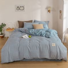 a blue and white checkered comforter on a bed