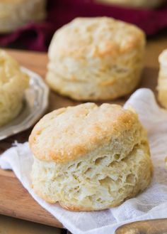 biscuits are sitting on a wooden cutting board