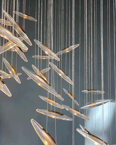 an artistic chandelier made out of glass and metal rods hanging from the ceiling