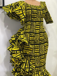 Ankara smocked dress with side ruffles made to fit. We have a vast variety of fabric to pick from Ruffled Smocked Dress For Party, Short Sleeve Stretch Dresses With Ruffles, Stretch Ruffle Dresses With Short Sleeves, Stretch Short Sleeve Dress With Ruffles, Party Smocked Dress With Ruffles, Yellow Fitted Dress With Ruffle Hem, Fitted Yellow Dress With Ruffle Hem, Yellow Knee-length Dress With Ruffle Hem, Fitted Smocked Dress With Ruffle Sleeves And Details