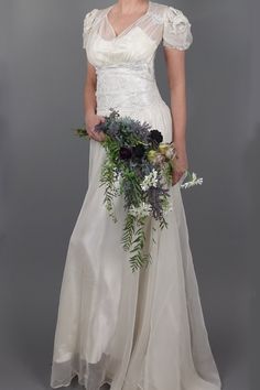 a woman in a wedding dress holding a bouquet