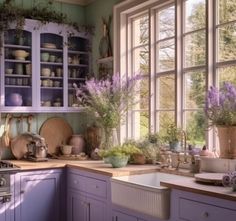 a kitchen filled with lots of purple cupboards next to a sink and stove top oven