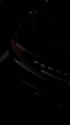 the back end of a black porsche car