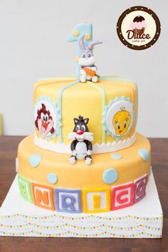 a birthday cake decorated with animals and letters