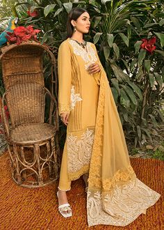 Simple Pakistani Party Dresses Embroidered Salwar Kameez is a charismatic masterpiece to have a head-turning appearance on the big day. This perfectly stitched Kameez Trouser is in lavish cotton fabric and is emblazoned with lavish designs and floral details. Kameez: The beautiful kameez in an alluring mustard shade comes in premium cotton fabric. The stunning cotton kameez is emblazoned with graceful embroidery work. Lavish designs and floral details give a perfect finishing to this mustard-hue Straight Kurta Dresses With Intricate Embroidery For Diwali, Semi-stitched Straight Kurta Dress With Resham Embroidery, Designer Chikankari Embroidery Dress For Diwali, Designer Dresses With Chikankari Embroidery For Diwali, Diwali Designer Dresses With Chikankari Embroidery, Straight Kurta Dress With Intricate Embroidery For Eid, Designer Yellow Churidar With Intricate Embroidery, Eid Dresses With Intricate Embroidery In Straight Kurta Style, Intricate Embroidery Lawn Suit For Eid