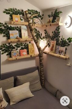 a bed room with a neatly made bed and a tree on the wall next to it