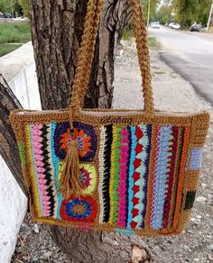 a crocheted purse hanging from a tree