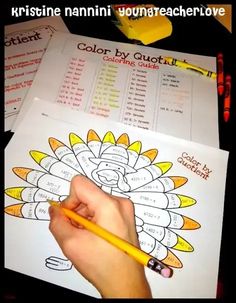 a person holding a pencil in front of a coloring book with words and pictures on it