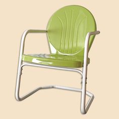 a lime green plastic chair with white frame and arm rests on a beige background,