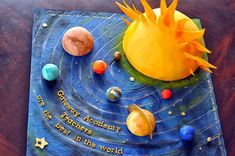 a birthday cake with the solar system on it's side and stars around it