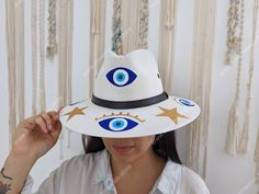 This listing is for one piece of this beautiful handmade straw hats. They are prefect to add to your closet for your favorite dress, providing shade from the warm summer sun. The eye decoration is hand painted. You will get the exact same piece shown on the pictures. These products are brand new. Measurements:  please see pictures for measurements. I love Mexico celebrates the native crafts of Mexico and the artists that produce them, enabling them and their communities to get recognized for the White Summer Straw Hat For Festival, Bohemian Straw Hat For Summer Gift, Bohemian Sun Hat As Summer Gift, Handmade Fedora Straw Hat For Vacation, Handmade Summer Fedora Panama Hat, Summer Handmade Panama Fedora Hat, Adjustable White Handmade Sun Hat, Adjustable Handmade White Sun Hat, Handmade White Beach Hats