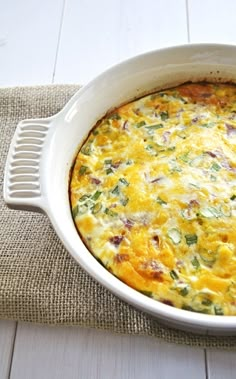 a casserole dish with cheese and vegetables in it