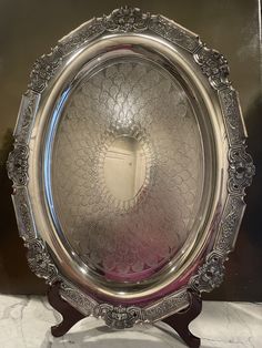 an ornate silver plate sitting on top of a table