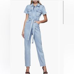 Update Your Street-Ready Style In This Light-Wash Jumpsuit Designed With An Edgy Front Zip And A Waist-Defining Tie. 54 1/2" Length; 28" Inseam; 13" Leg Opening (Size 1) Front Zip Closure Spread Collar Short Sleeves Chest Flap-Patch Pockets; Front Scoop Pockets; Back Patch Pockets Fitted Blue Denim Jumpsuit With Belt, Fitted High Rise Jumpsuits For Workwear, Fitted High-rise Jumpsuits For Workwear, Spring Fitted Denim Jumpsuit With Belt, Belted Fitted Denim Jumpsuit For Spring, Fitted Belted Denim Jumpsuit For Spring, High Rise Jumpsuits For Workwear In Summer, High Rise Jumpsuits And Rompers For Summer Workwear, Good American Jumpsuit