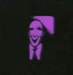 a man in a suit and tie with a creepy face on it's screen