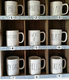 coffee mugs are lined up on shelves with numbers