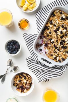 a bowl of granola next to bowls of fruit and yogurt