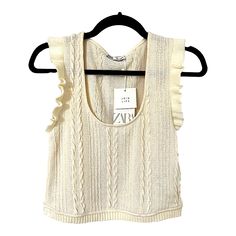 - Sleeveless With Trendy Ruffle Trim - Ivory/Cream Color - Cable Knit - Size Large (Runs A Little Small) - Pit To Pit 16" Across Stretches To 17.5" - Length 18" - 100% Polyester - Nwt White Sleeveless Sweater Vest For Day Out, Zara Cream Sleeveless Top, Zara Sleeveless Cream Top, Beige Knit Tops With Ruffles, Chic Zara Cable Knit Tops, White Pointelle Knit Tank Top For Spring, White Pointelle Knit Sleeveless Sweater Vest, White Pointelle Knit Sweater Vest For Spring, White Cable Knit Tops For Spring