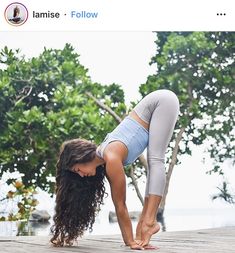 a woman is doing yoga on a dock