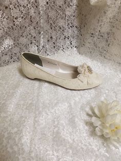 So elegant Satin lace shoes for the Bride who demands elegance & comfort! These are only 1/2 heels almost flat! Elegant lace, with my handmade Ivory Lace Flowers with crystals Brooch! Brooch: Gold tone, or Silver tone; The outer sole is leather,, the inside sole is man made material and cushioned for extra comfort! Colors available: WHITE OFF-WHITE, IVORY, CHAMPAGNE, US SIZES: M width, standard width Sizes: 5, 5.5, 6, 6.5, 7, 7.5, 8, 8.5, 9, 9.5, 10, 11, 12 Outside USA buyers please goggle a Elegant Cream Low Heel Flats, Elegant Almond Toe Ballet Flats For Wedding, Elegant Low Heel Lace Wedding Shoes, Elegant Lace Wedding Shoes With Low Heel, Elegant Cream Flats For Party, Elegant Cream Flats With Round Toe, Feminine Low Heel Wedding Flats, Feminine Low Heel Flats For Wedding, Elegant Cream Ballet Flats With Almond Toe