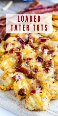 loaded tater tots on a cutting board with bacon and cheese in the background