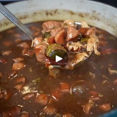 a spoon full of soup with meat and vegetables