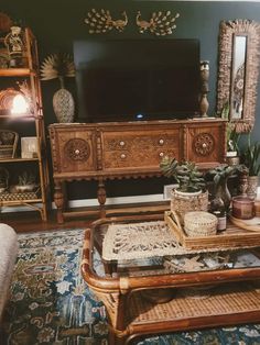 a living room filled with furniture and a flat screen tv on top of a wooden stand