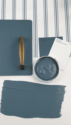 a table topped with blue paint and a brush