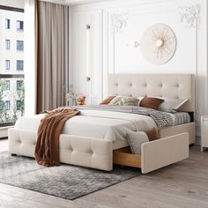 a bedroom with white walls and wooden floors