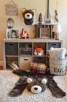 a teddy bear is laying on the floor in front of a shelf with other items