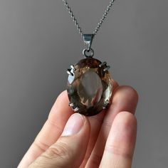 Smoky Quartz Pendant - Large Smoky Quartz Necklace - Quartz Pendant - Smoky Quartz Jewelry - Quartz - Sterling Silver and Smoky Quartz Gemstone: Natural Smoky Quartz Metal: 925 Sterling Silver Stone Cut: Faced Stone Size: 36 mm x 28.2 mm - 1.41 in x 1.11 in Pendant Size: 51 mm x 28.2 mm - 2.01 in x 1.11 in Weight: 27 grams (135 carats ) total weight of stone and metal.  For ring orders, ring resizing is free.  Chains are gifts for necklace orders..  Note: We don't use any filters for photos. The details may not be clear. Feel free to contact us with any questions, special orders or additional photo or video requests. We will be happy to provide more information! :) WORLDWIDE FedEx, UPS or TNT EXPRESS MAIL SERVICE (Delivery time: 1 - 5 business days.) LAYAWAY PAYMENT PLAN is available. ABOU Smoky Quartz Jewelry, Oxidized Silver Necklace, Smoky Quartz Necklace, Smoky Quartz Pendant, Religious Ceremony, Quartz Jewelry, Payment Plan, Spirituality Energy, Oxidized Silver