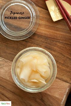 pickled ginger in a glass jar on a wooden cutting board with chopsticks